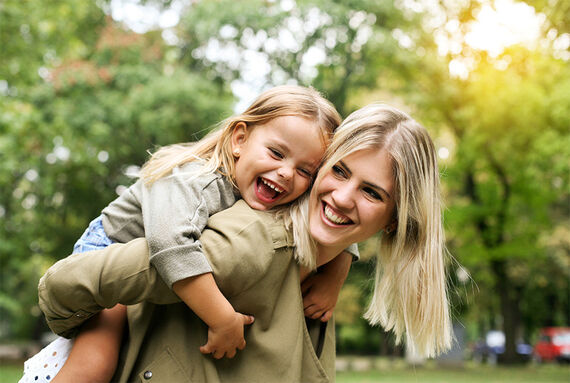 Mother carrying girl piggyback