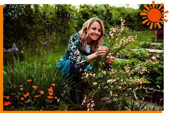 Woman picking homegrown flowers in her garden